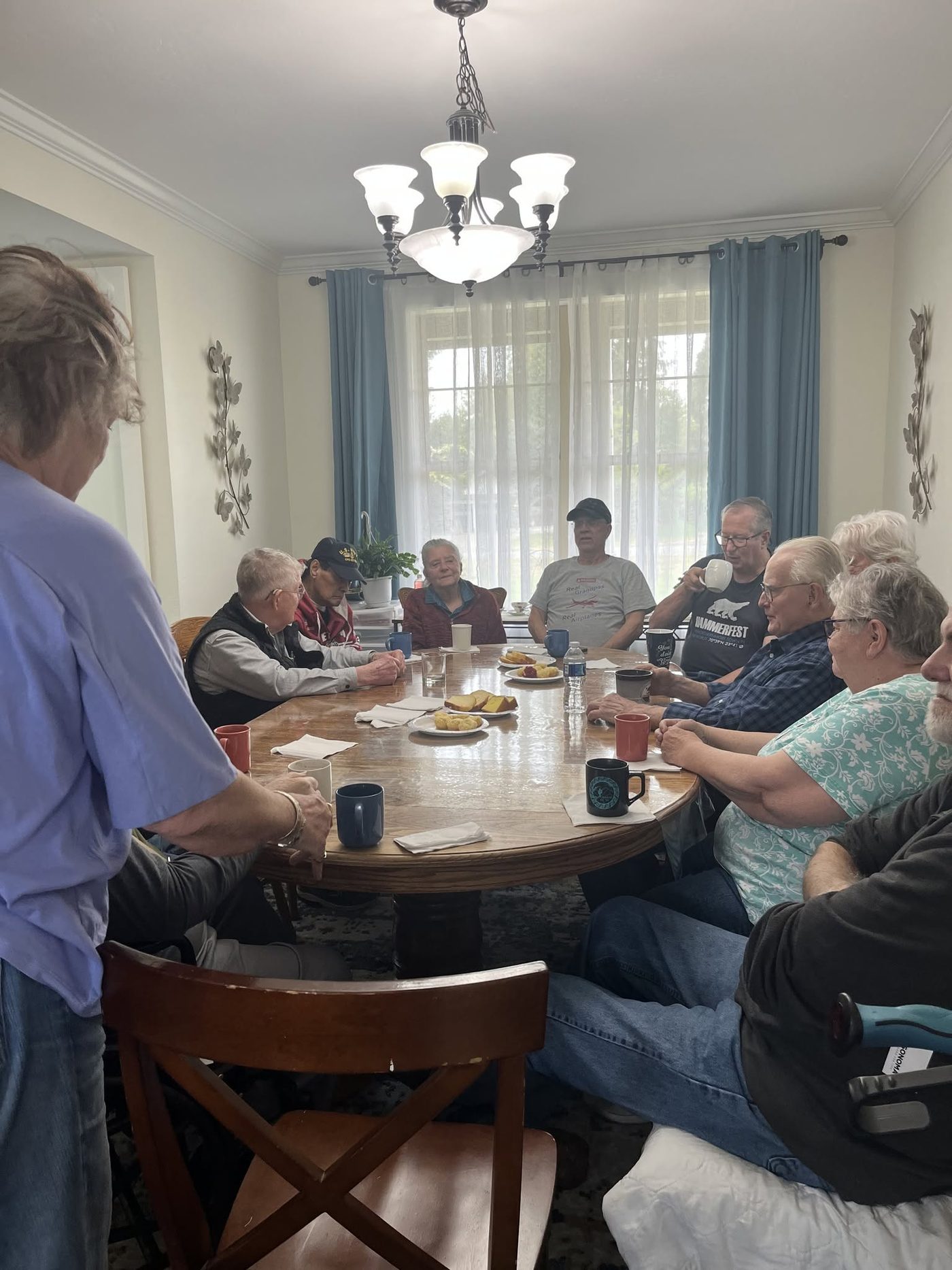 Residents sharing a meal around the dining table at Leeside Manor