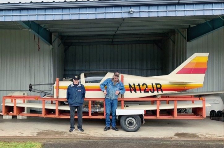 Members with a finished aircraft at the hangar