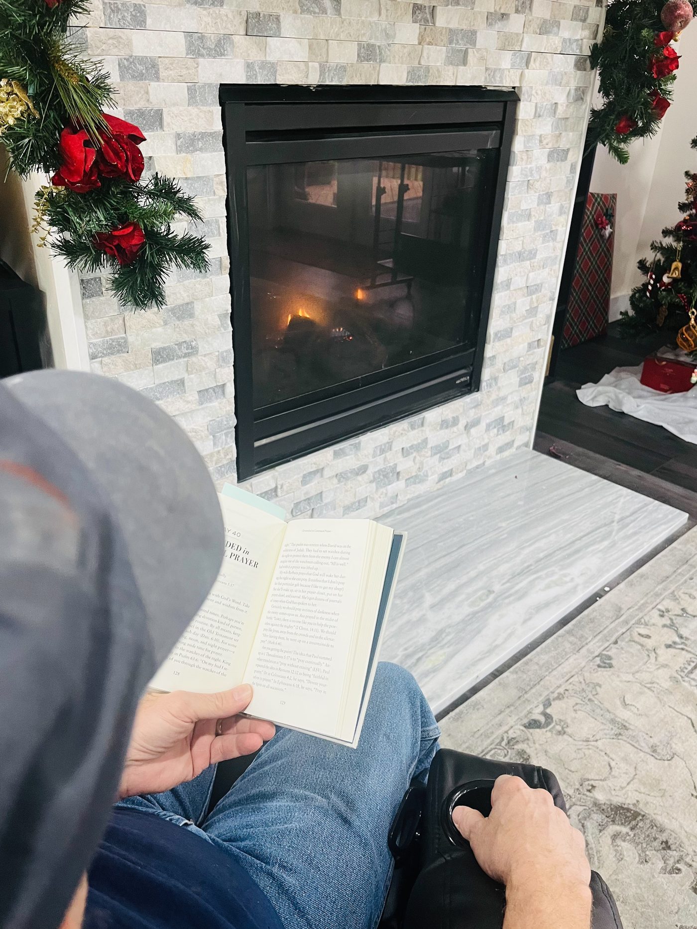 Reading by the fireplace at Leeside Manor